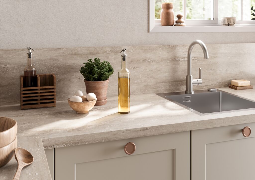 Impuls IP 4250 shaker base units with travertine-effect worktop, undermount sink and copper knobs