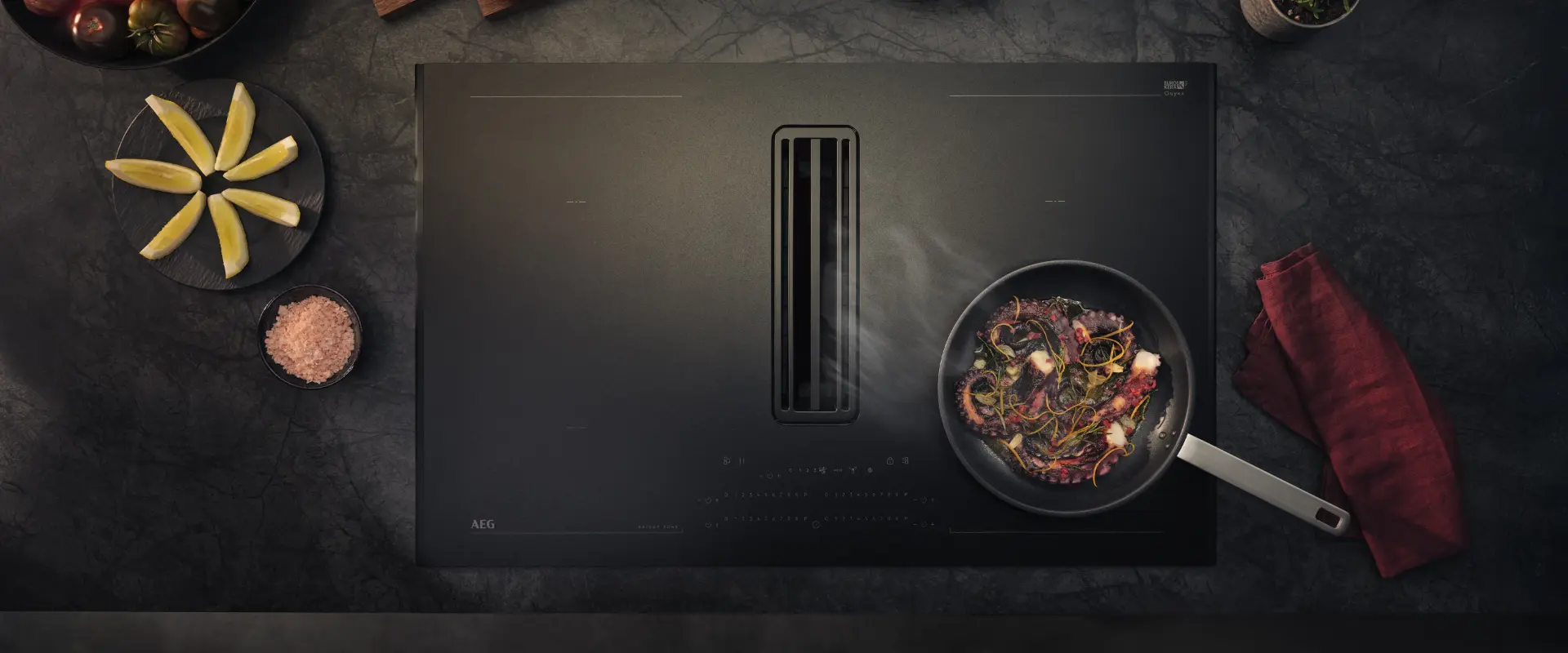 Overhead view of an AEG induction hob with integrated downdraft extraction