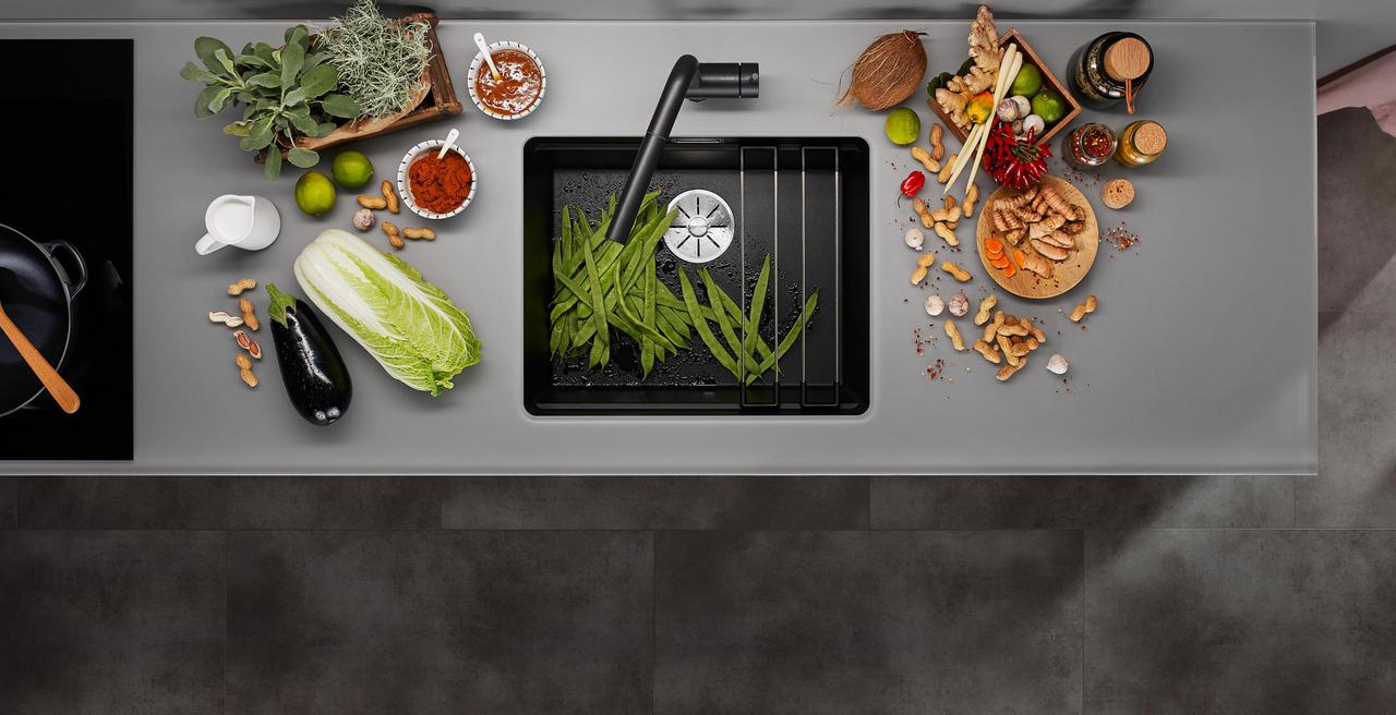 Blanco Etagon sink with a stepped ledge holding a rail and colander over the bowl