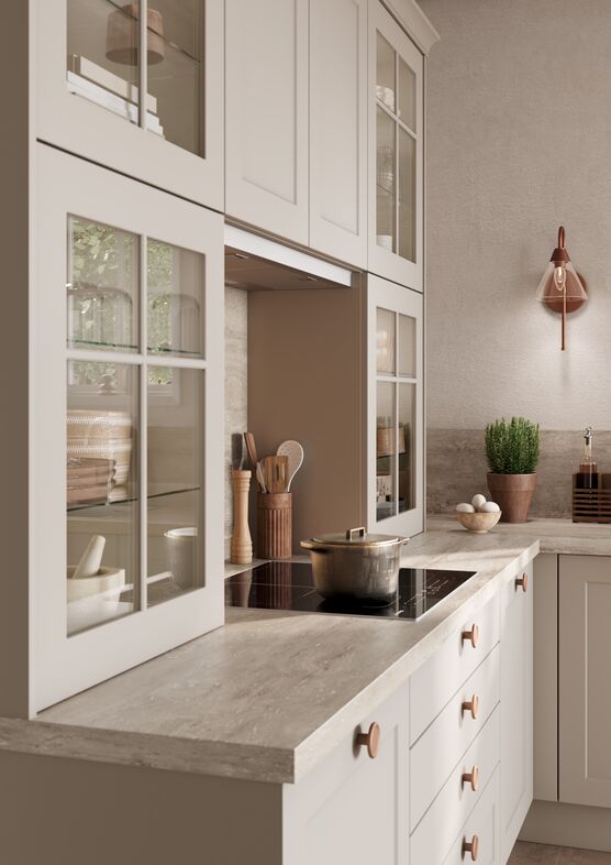 Impuls IP 4250 shaker kitchen with glazed wall cabinets, stone worktop and copper wall light