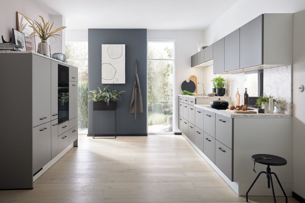 Compact Impuls German kitchen with efficient storage and pale cabinetry