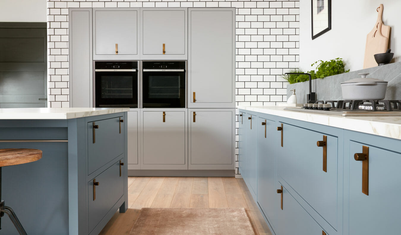 Bespoke handmade painted shaker kitchen in soft blue with brass handles