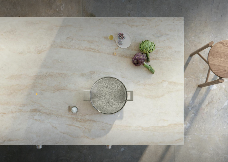 Pale travertine effect Dekton table top viewed from above in sunlight